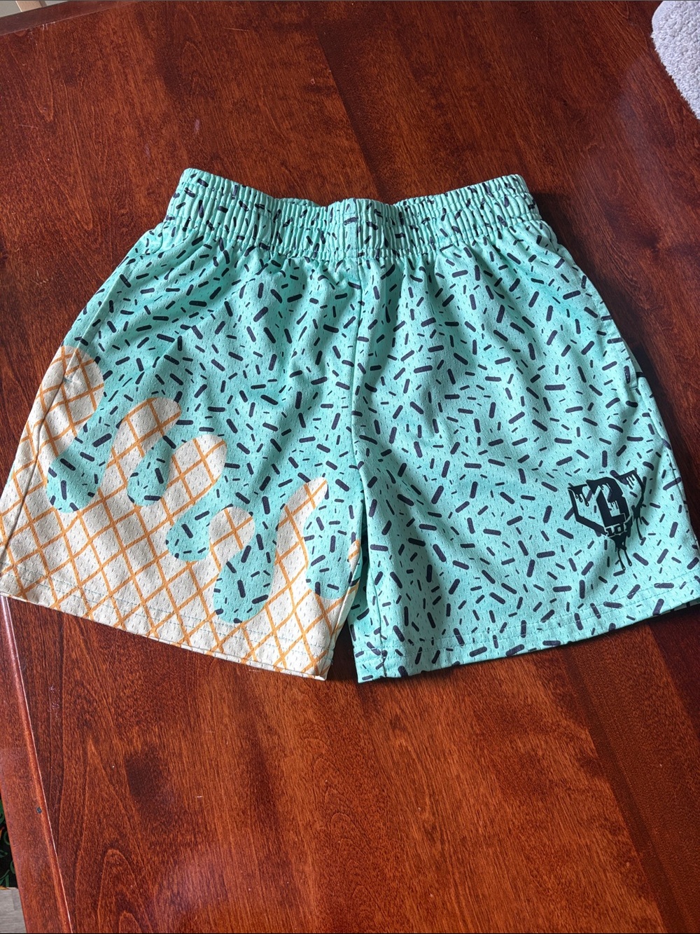 Kids Mint Green Swim Shorts with Orange Patterned Accents